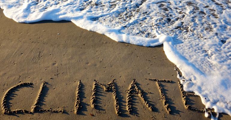 "climate" written on a beach