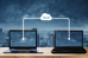 Computer laptops sharing data through cloud storage