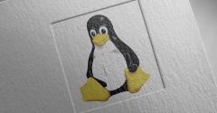 Linux Tux penguin logo on paper