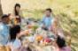 young people eating at a picnic table
