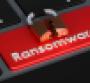 a red button on a keyboard says ransomware