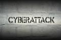 the word cyberattack written on a wall